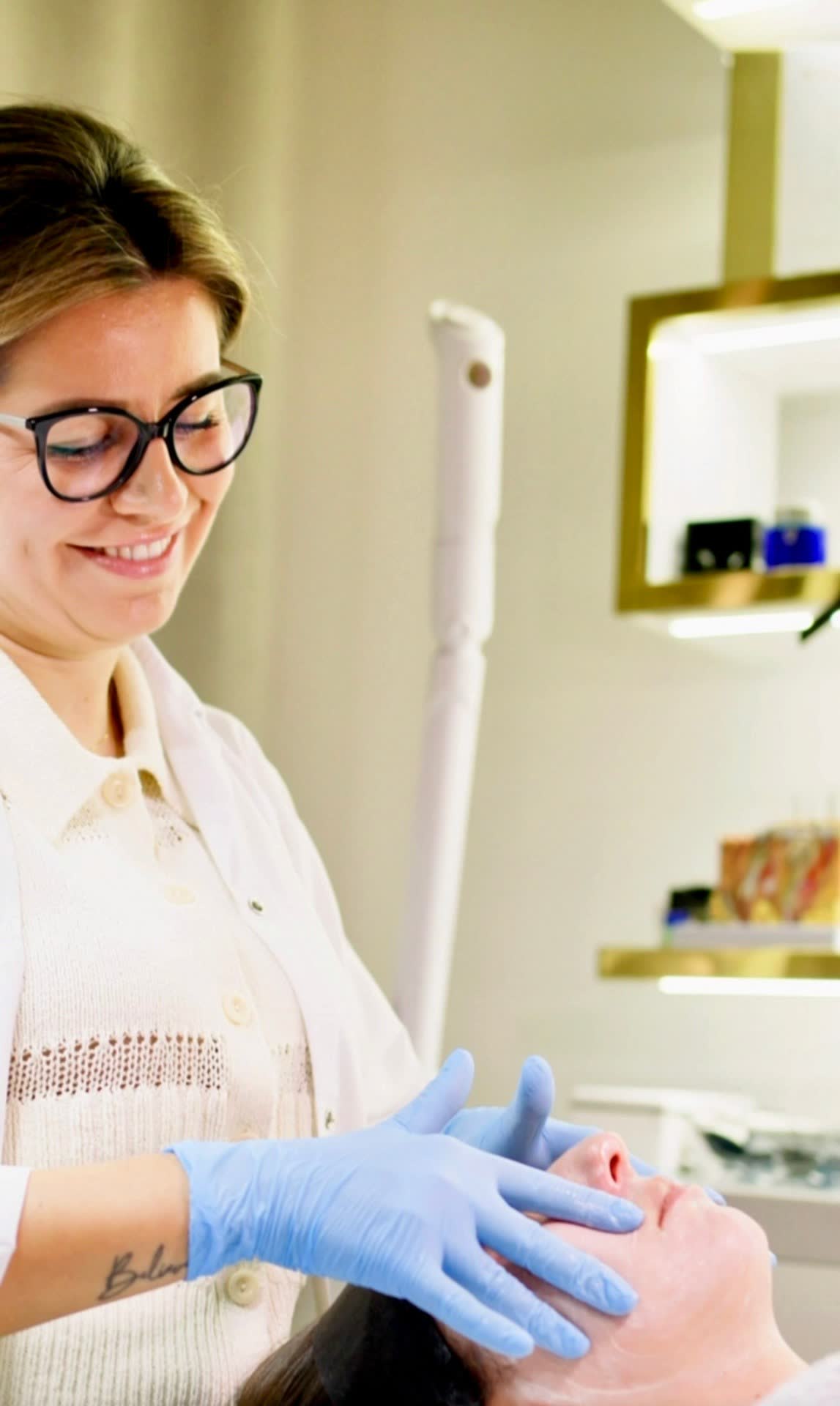 Ludmila performing a microcurrent treatment on a client